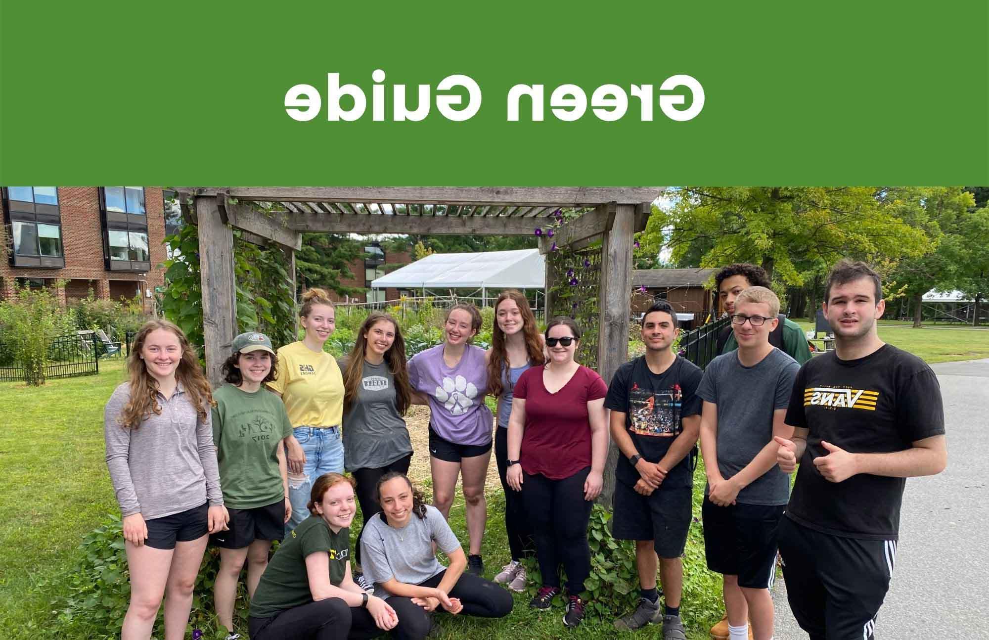 A group of students stand together in front of the garden after an orientation event